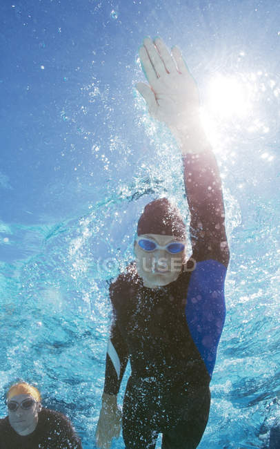 Confident and strong triathlete in wetsuit underwater — Stock Photo