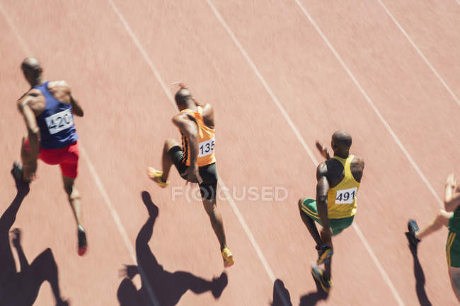 Runners racing on track during daytime — Stock Photo