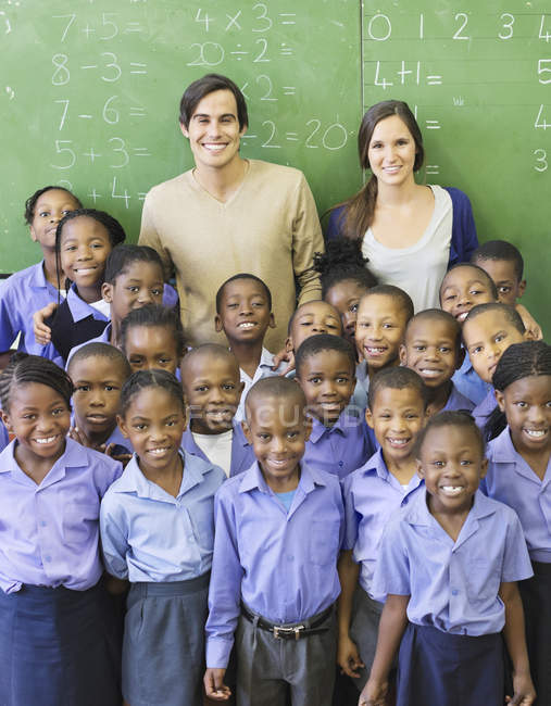 African american students and teachers smiling in class — Stock Photo