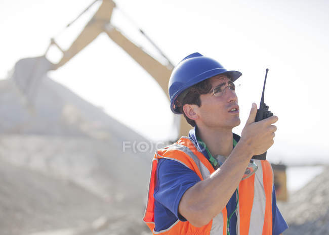 Worker using walkie-talkie in quarry — Stock Photo