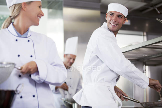 Chefs talking in restaurant kitchen — Stock Photo