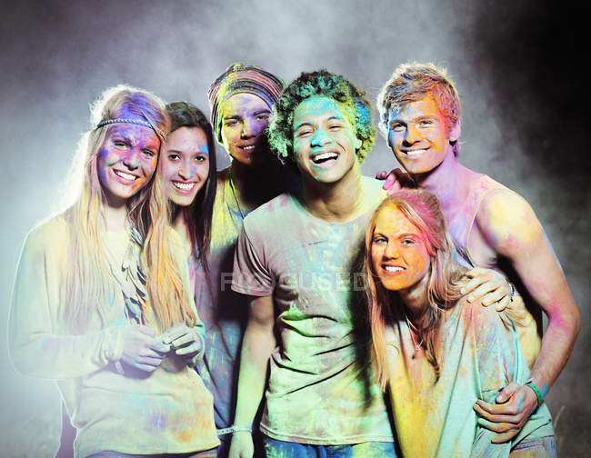 Portrait of friends covered in chalk dye at music festival — Stock Photo