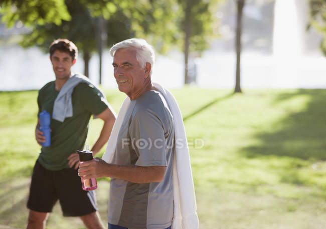 Men drinking water after workout — Stock Photo
