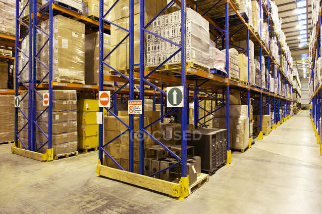 Aisles of boxes in warehouse — Stock Photo