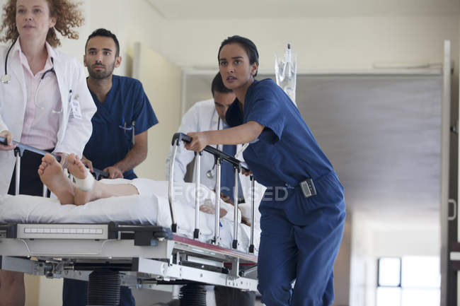 Hospital staff rushing patient to operating room — Stock Photo