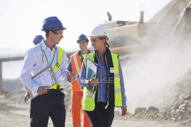Business people talking in quarry — Stock Photo