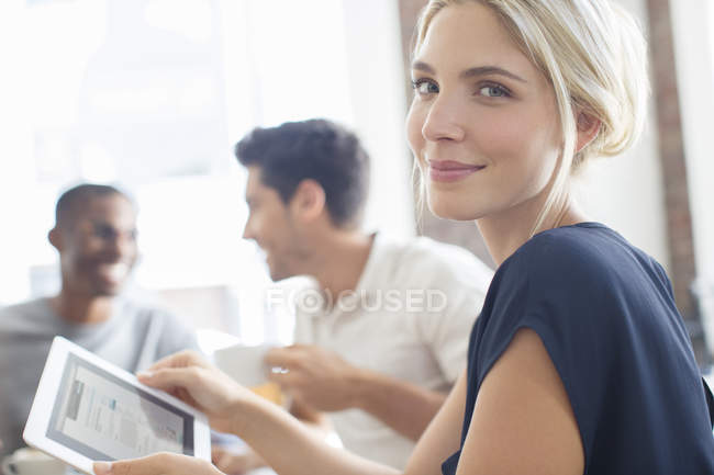 Businesswoman using digital tablet at meeting — Stock Photo