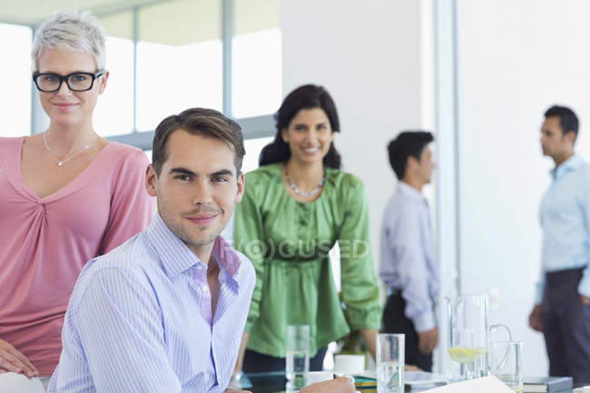 Business people smiling at modern office — Stock Photo