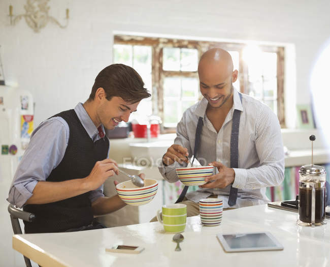 Young happy businessmen having breakfast together — Stock Photo