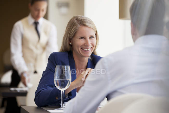 Business people smiling in restaurant — Stock Photo