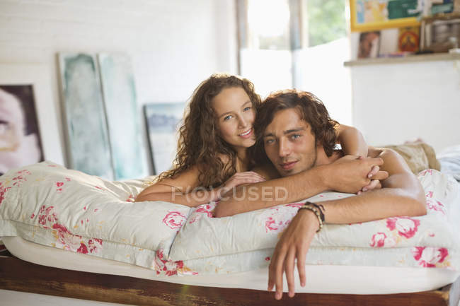 Jovem casal feliz relaxar juntos na cama — Fotografia de Stock