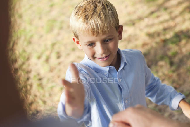Father and son high fiving outdoors — Stock Photo