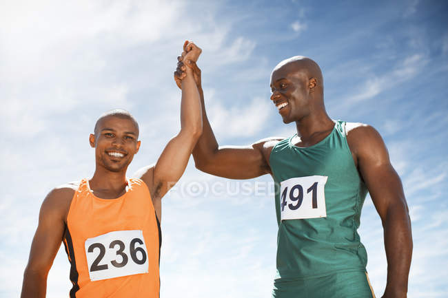 Atletas comemorando juntos na pista — Fotografia de Stock
