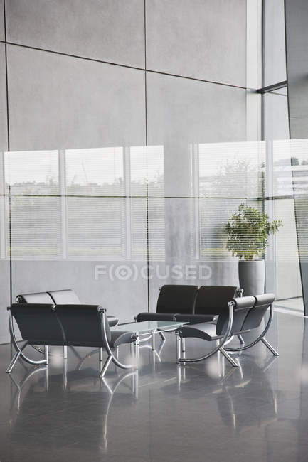 Chairs and table in office lobby area — Stock Photo