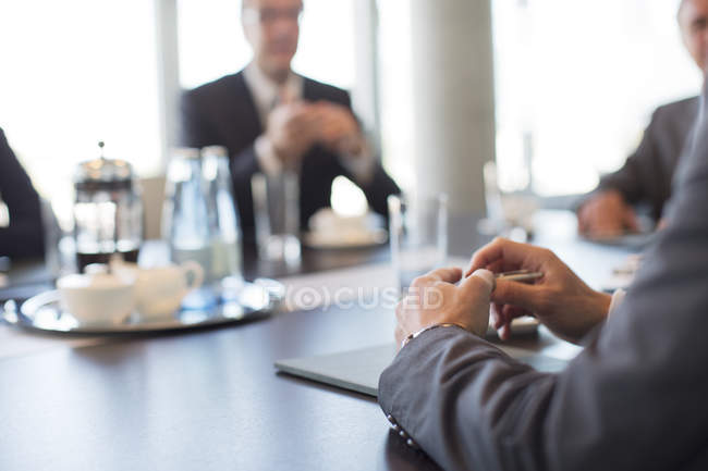 Close up of businessman hands in meeting at modern office — Stock Photo