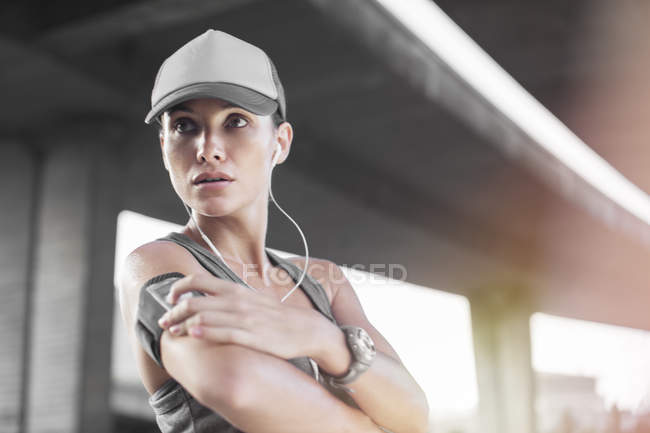 Woman playing music before exercising — Stock Photo