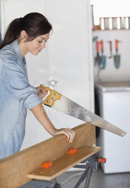 Skillful caucasian woman working in workshop — Stock Photo