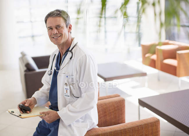 Portrait of smiling doctor in hospital lobby — Stock Photo