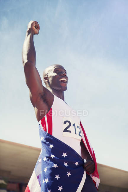 Track and field athlete cheering on track — Stock Photo