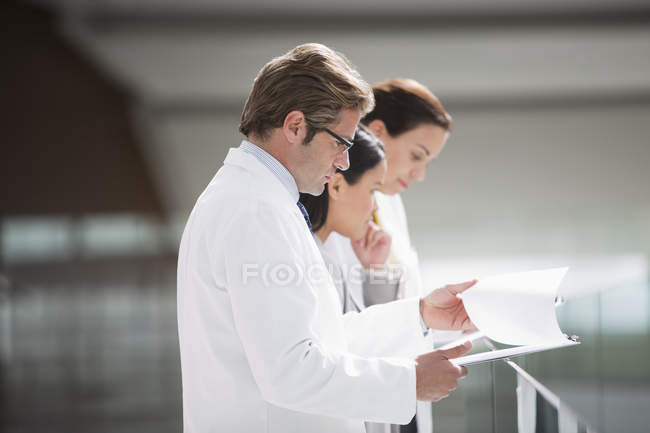 Médecins examinant les dossiers médicaux — Photo de stock