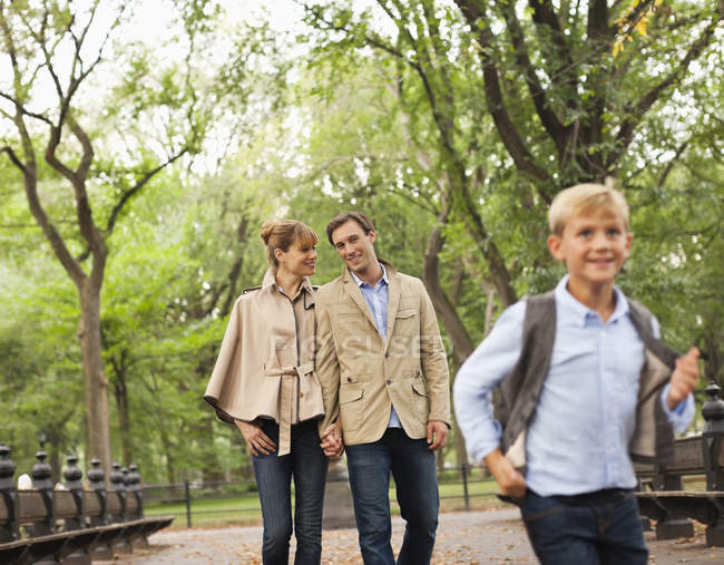 Family walking together in park — Stock Photo