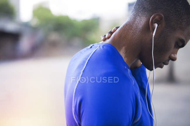 Man resting after exercising on city street — Stock Photo