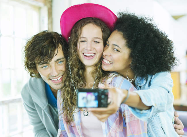 Friends taking picture together indoors — Stock Photo
