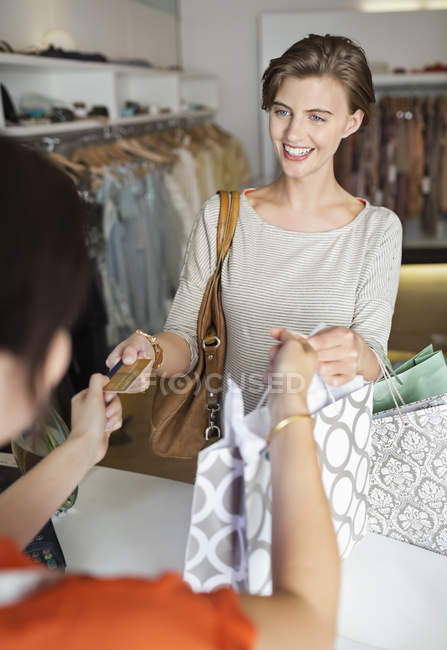 Woman shopping in clothes store — Stock Photo