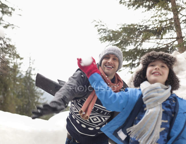 Father and son enjoying snowball fight — Stock Photo