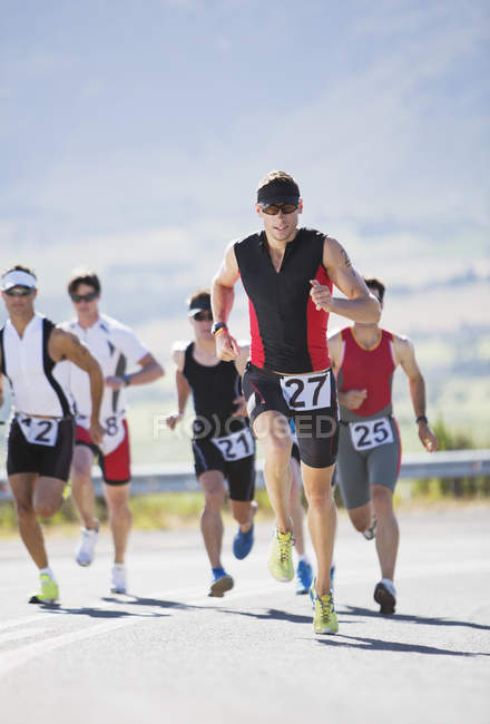 Runners in race on rural road — Stock Photo
