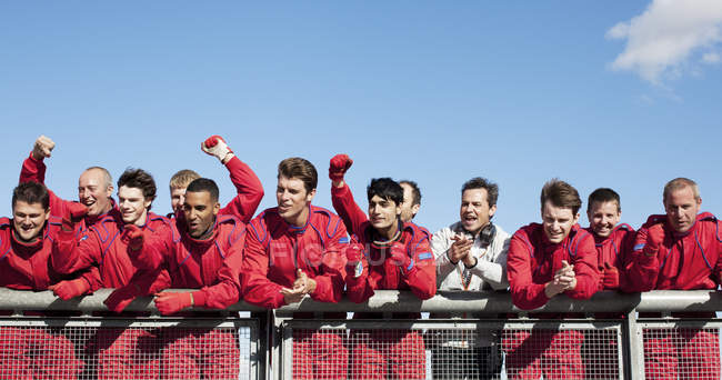 Racing team cheering on sidelines — Stock Photo