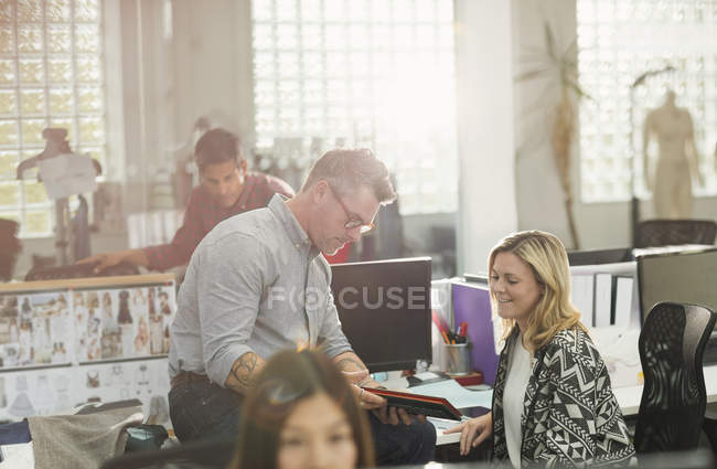 Fashion designers using digital tablet in office — Stock Photo