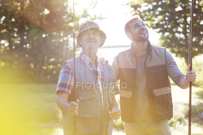 Отец и взрослый сын с удочками — стоковое фото