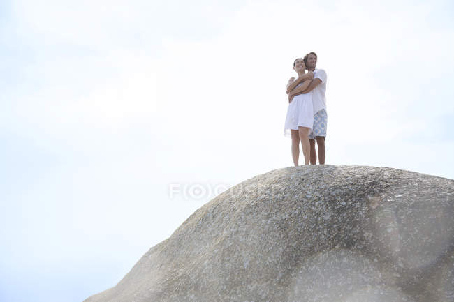 Couple hugging on rock formation — Stock Photo