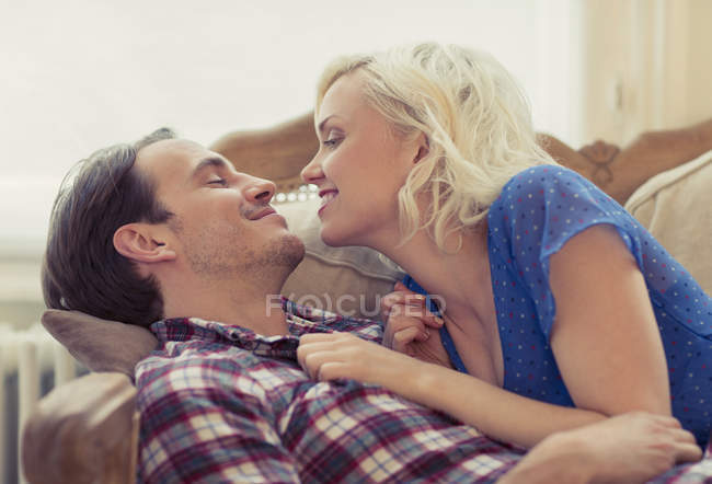 Couple affectueux posé sur le canapé — Photo de stock