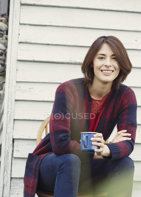 Portrait smiling brunette woman drinking coffee outdoors — Stock Photo