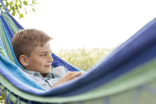 Boy relaxing in hammock — Stock Photo