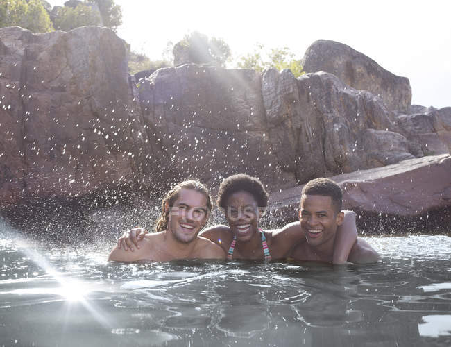 Portrait of smiling friends in river — Stock Photo