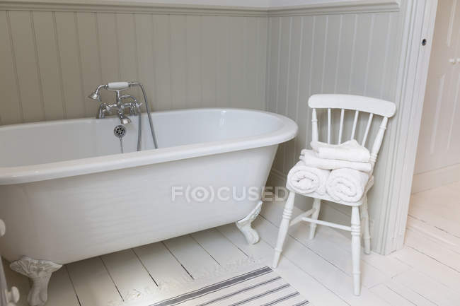 Baignoire et chaise dans salle de bain ornée — Photo de stock