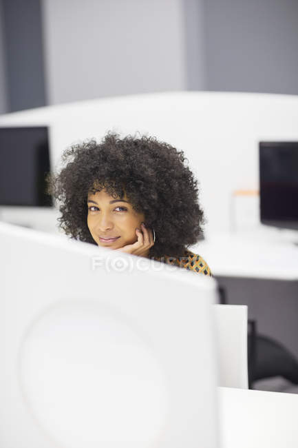 Businesswoman smiling at desk in modern office — Stock Photo