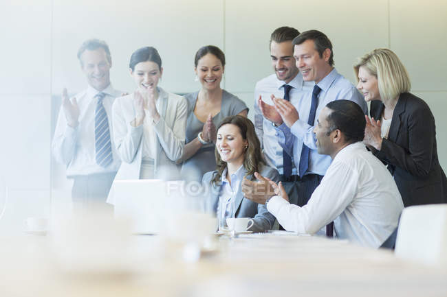 Business people cheering in meeting — Stock Photo