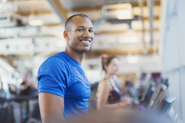 Portrait smiling man on treadmill at gym — Stock Photo