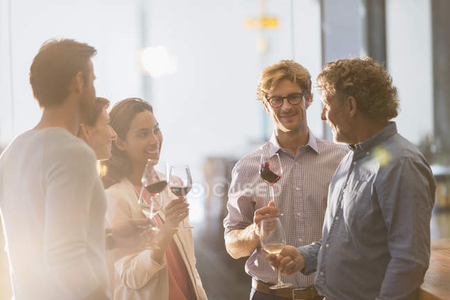 Friends wine tasting in winery tasting room — Stock Photo