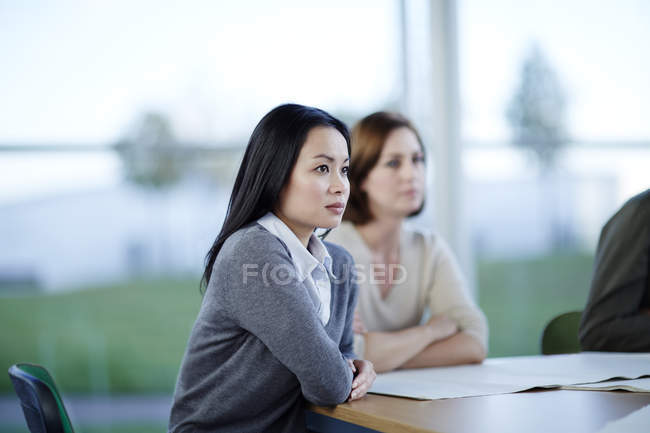 Successful adult businesswomen in meeting together — Stock Photo
