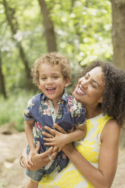 Portrait enthusiastic mother and son in woods — Stock Photo
