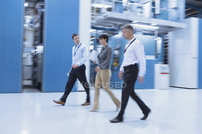 Workers walking in factory indoors — Stock Photo