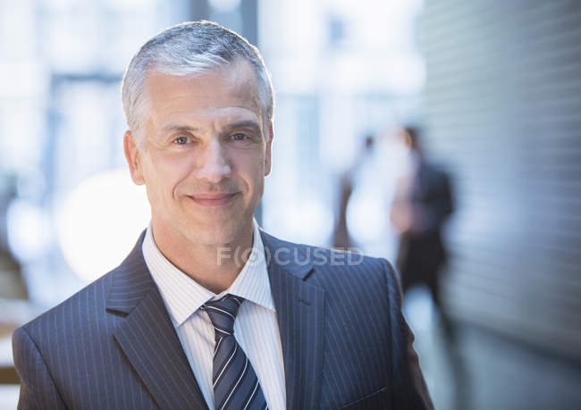 Businessman smiling in office — Stock Photo