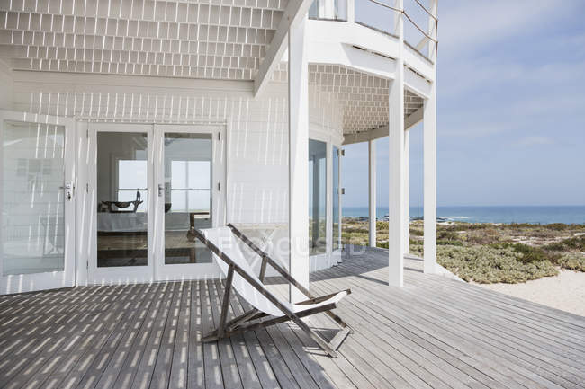 Палубне крісло на палубі з видом на пляж — стокове фото