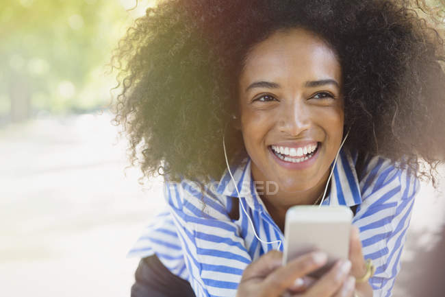 Enthusiastic woman listening to music with headphones and mp3 player — Stock Photo