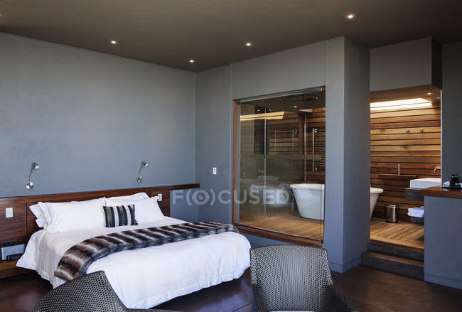 Modern bedroom and bathroom indoors — Stock Photo